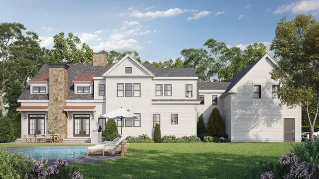 a front view of a house with a garden and plants