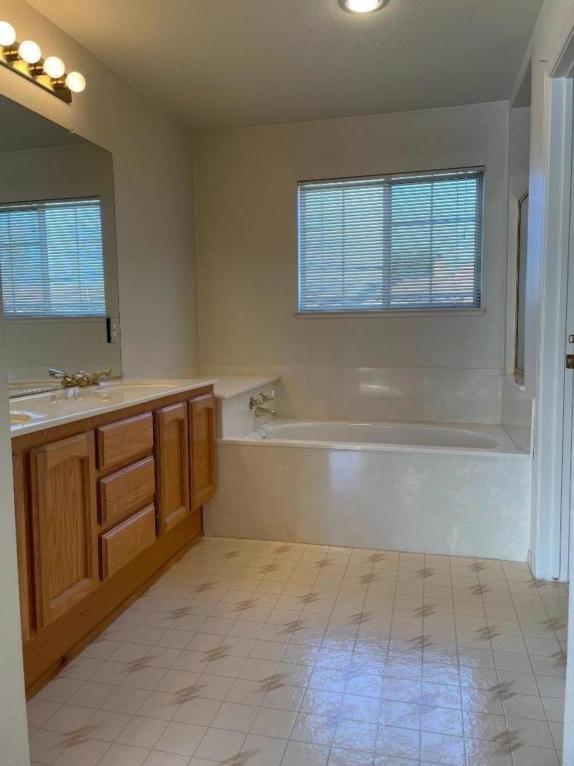 1656 Klipspringer Drive San Jose, CA 95124 - Photo 14 of 19 a view of a bathroom with a bathtub and window