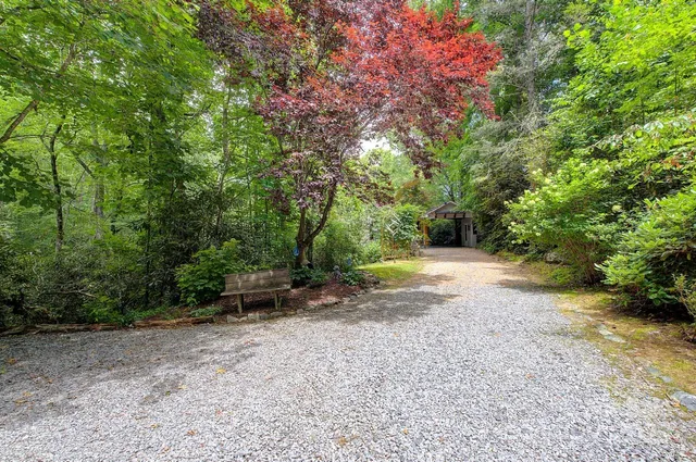 a view of a bedroom with wooden floor and windows
