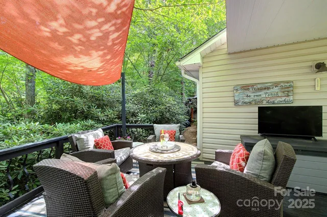 a view of a patio with couches table and chairs and potted plants