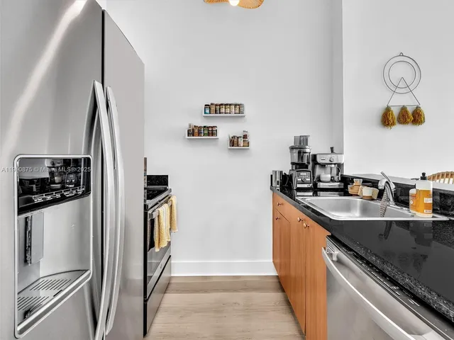 a kitchen with sink and a window