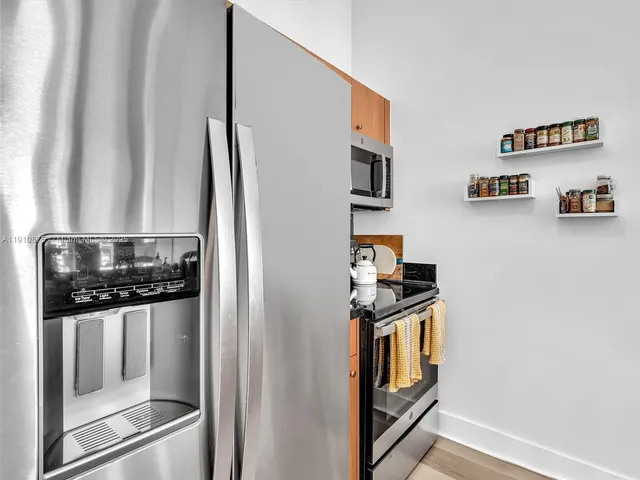a kitchen with a sink appliances and cabinets