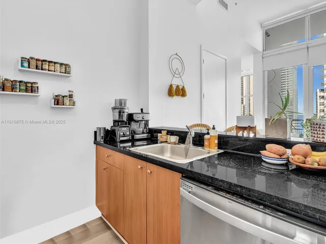 a kitchen with stainless steel appliances granite countertop a refrigerator and a sink