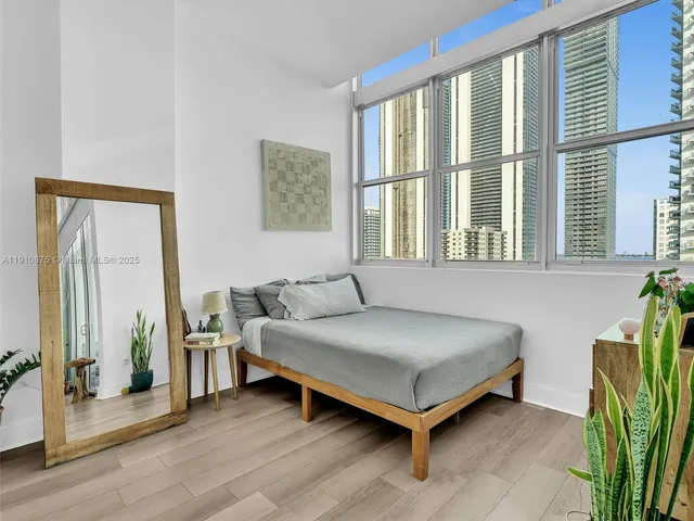 a bedroom with a bed and windows