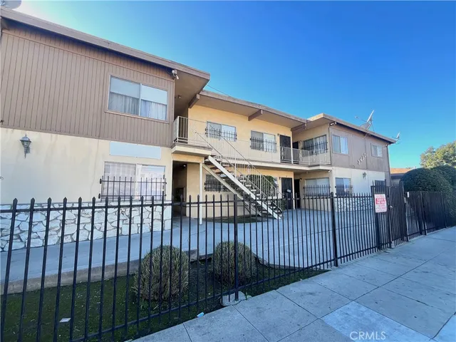 a view of a house with wooden fence