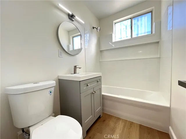 a bathroom with a toilet sink and a mirror