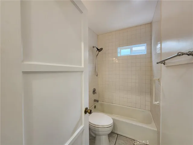 a bathroom with a shower a toilet and a sink