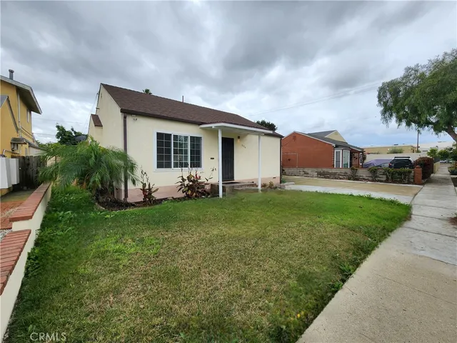 a view of a house with backyard sitting area and garden
