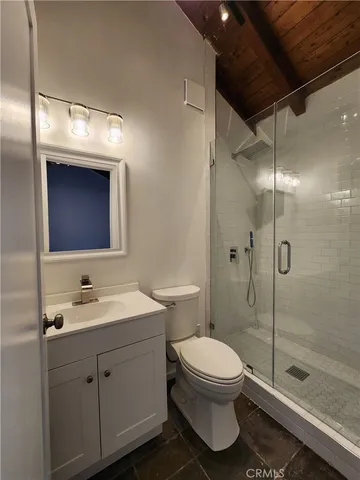 a bathroom with a toilet sink and shower