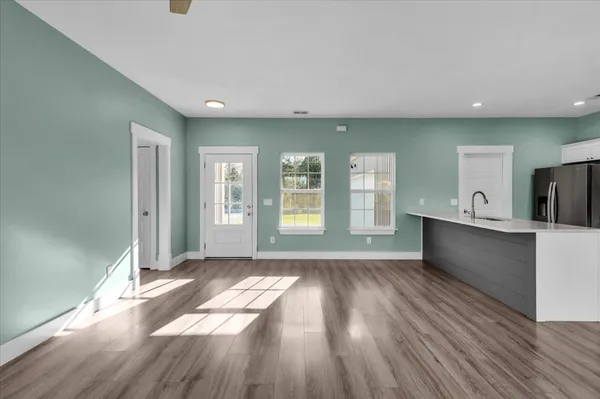a view of a room with window wooden floor and chandelier