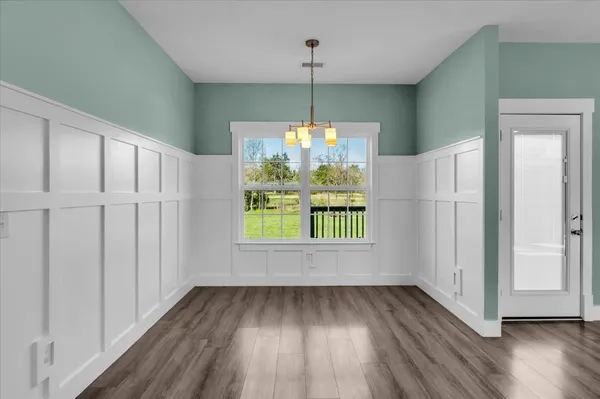 a kitchen with stainless steel appliances a sink a stove a microwave and cabinets