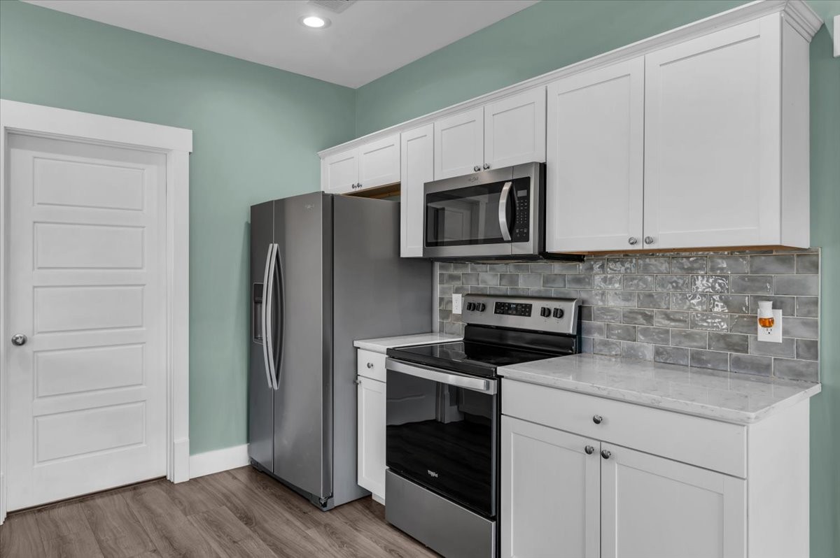 3164 Rucker Road Christiana, TN 37037 - Photo 19 of 67 a kitchen with white cabinets stainless steel appliances and a counter space