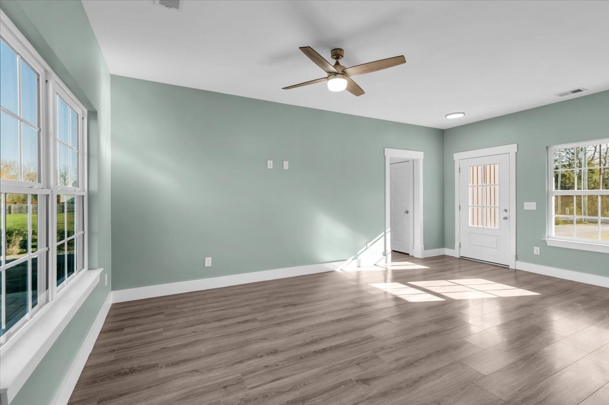 3164 Rucker Road Christiana, TN 37037 - Photo 9 of 67 an empty room with wooden floor and windows