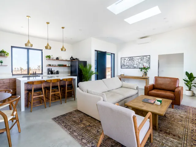 a kitchen with a sink a stove and chairs