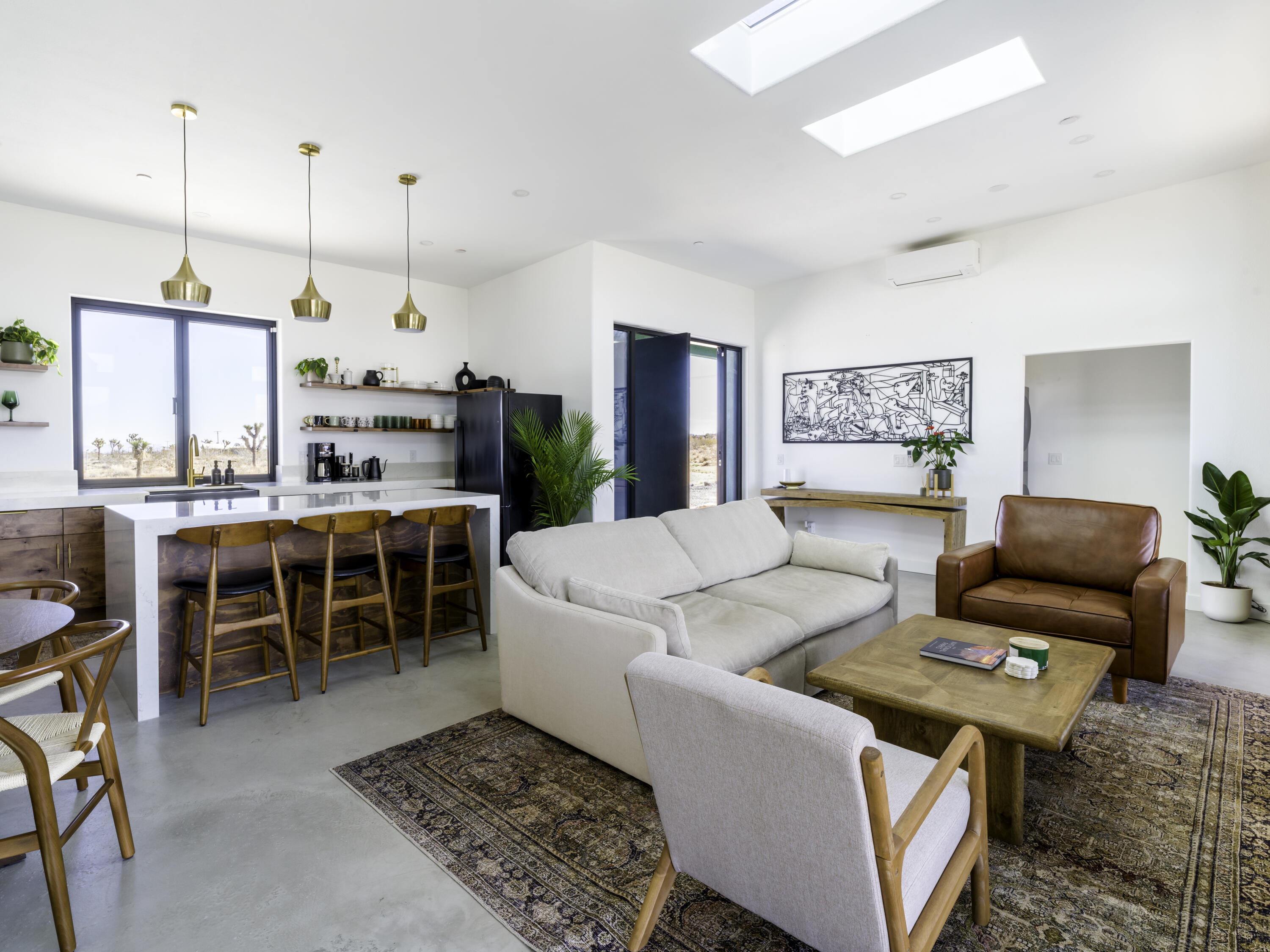 59130 Reche Road Landers, CA 92285 - Photo 11 of 71 a living room with furniture a rug and kitchen view