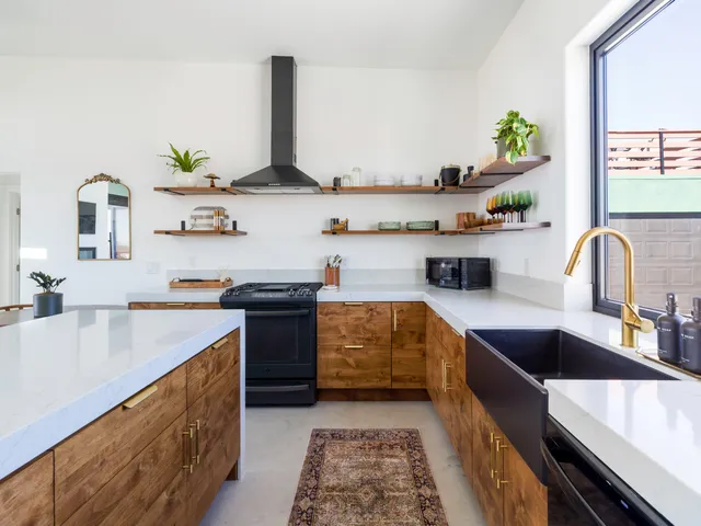 a kitchen with stainless steel appliances granite countertop a sink a stove and a refrigerator