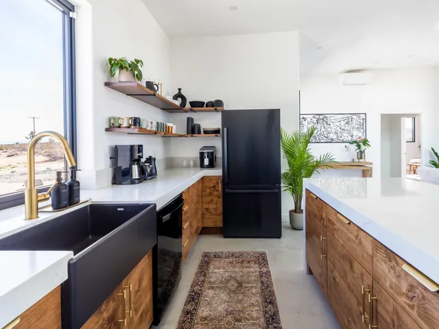 a kitchen with a large window and stainless steel appliances