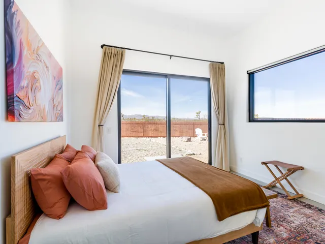 a bedroom with a bed and a mirror