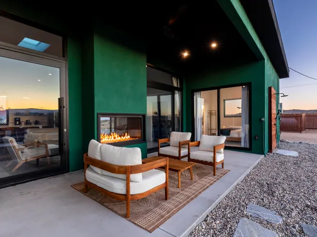 a living room with furniture kitchen view and a chandelier