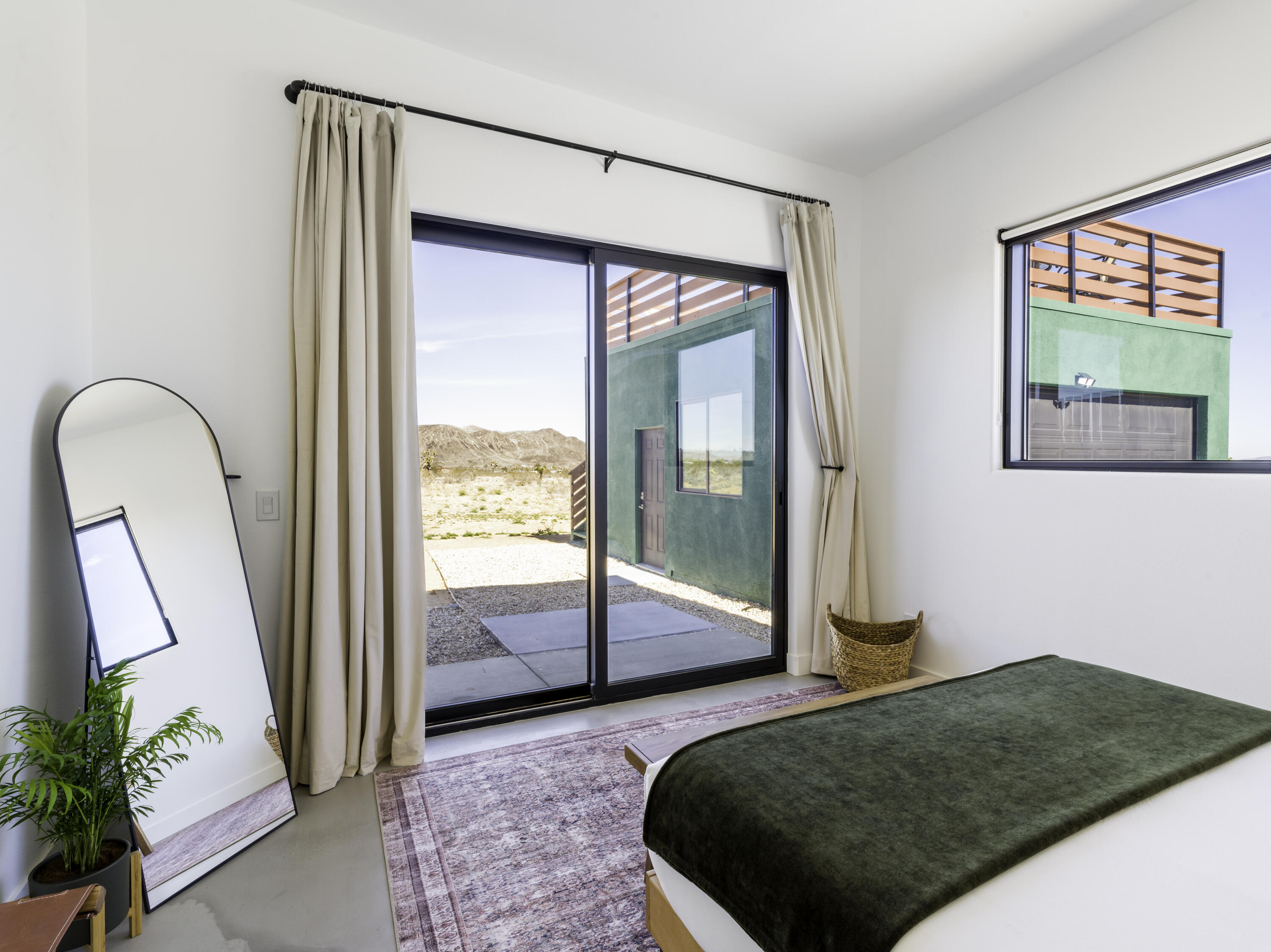 59130 Reche Road Landers, CA 92285 - Photo 37 of 71 a bedroom with a bed and a mirror