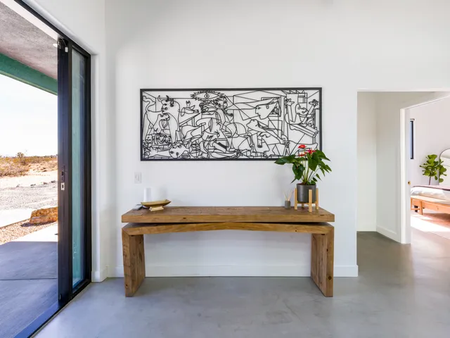 a kitchen with a large window and stainless steel appliances