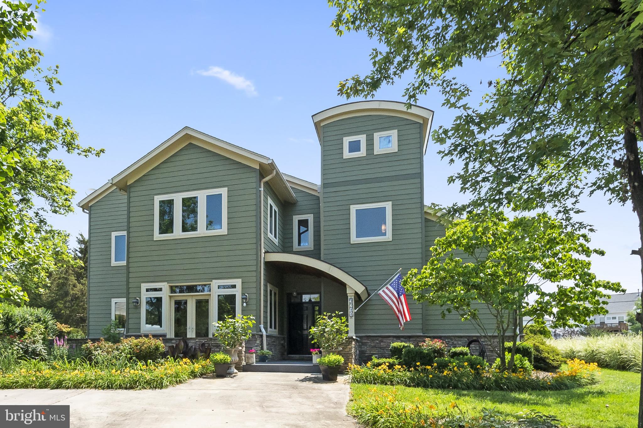 a front view of a house with a garden
