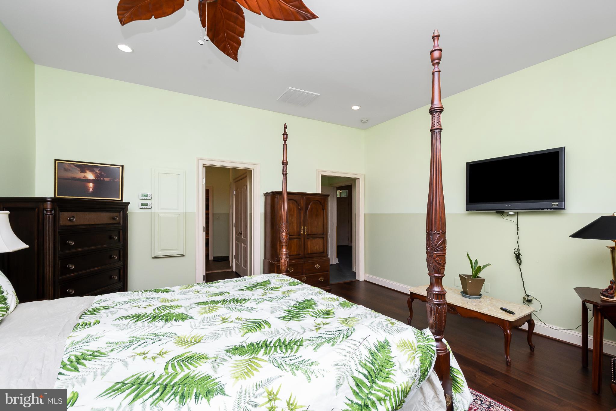 9211 Ox Road Lorton, VA 22079 - Photo 15 of 44 a bedroom with a bed and a flat tv screen on dresser
