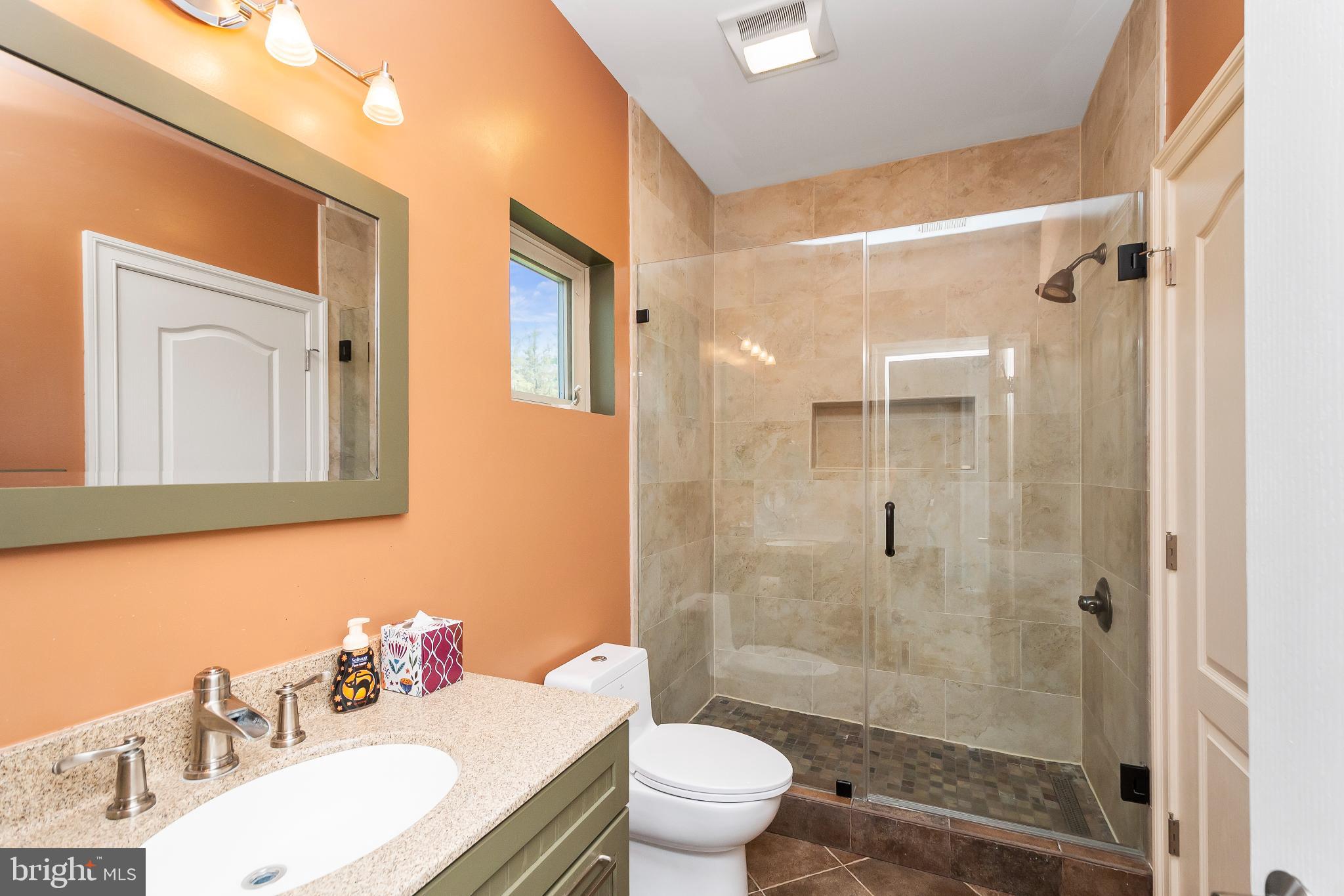9211 Ox Road Lorton, VA 22079 - Photo 28 of 44 a bathroom with a sink toilet a mirror and shower