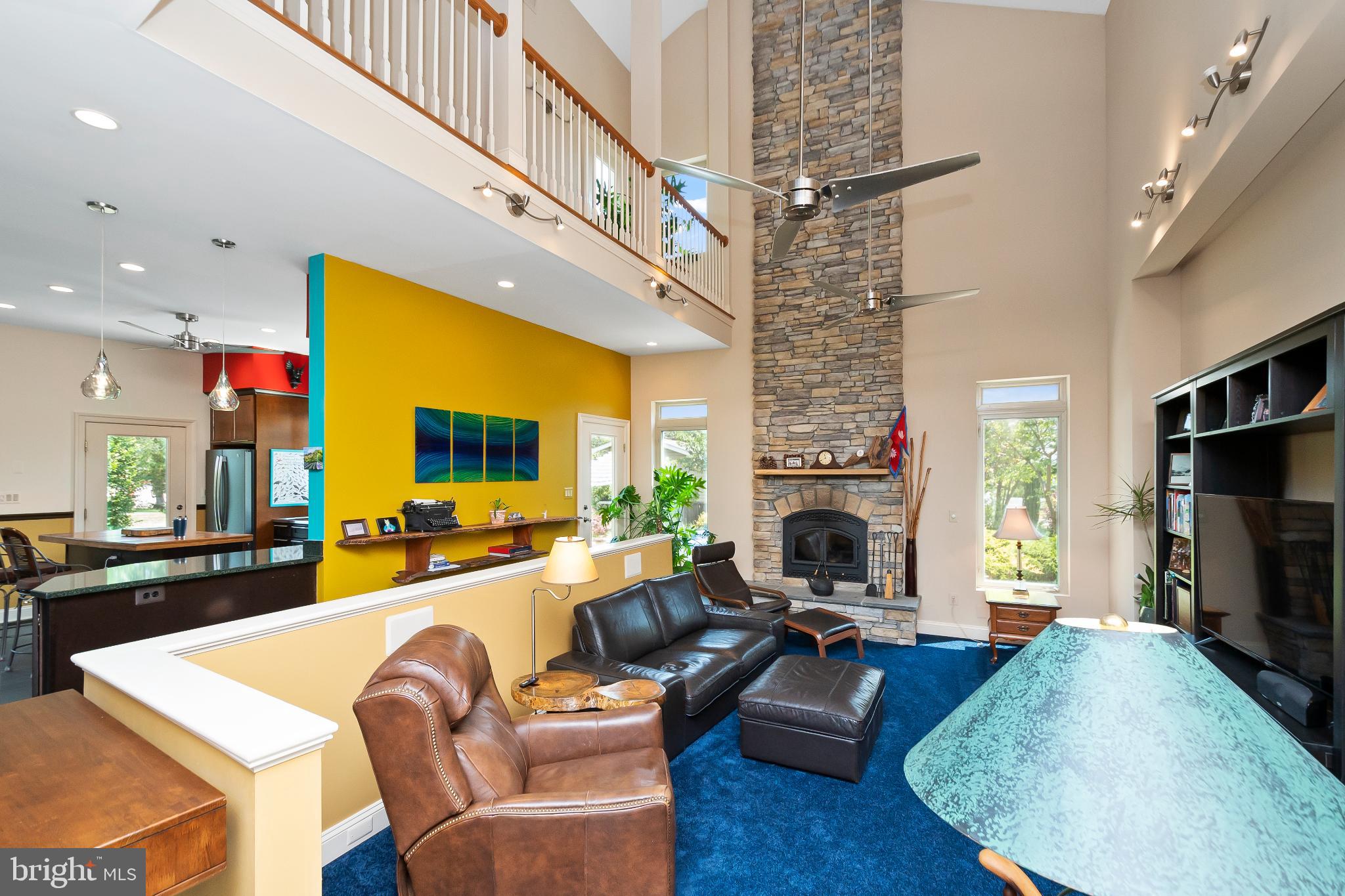 9211 Ox Road Lorton, VA 22079 - Photo 4 of 44 a large living room with furniture a fireplace and a flat screen tv