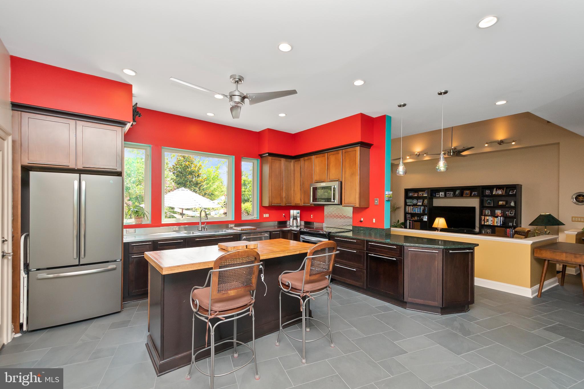 9211 Ox Road Lorton, VA 22079 - Photo 7 of 44 a kitchen with stainless steel appliances a stove a refrigerator a kitchen island a sink and chairs