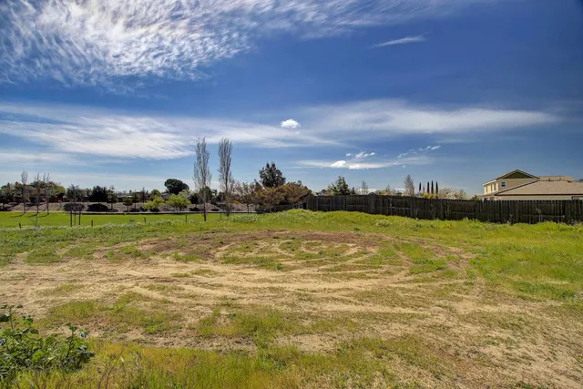 a view of a lake with houses in the back