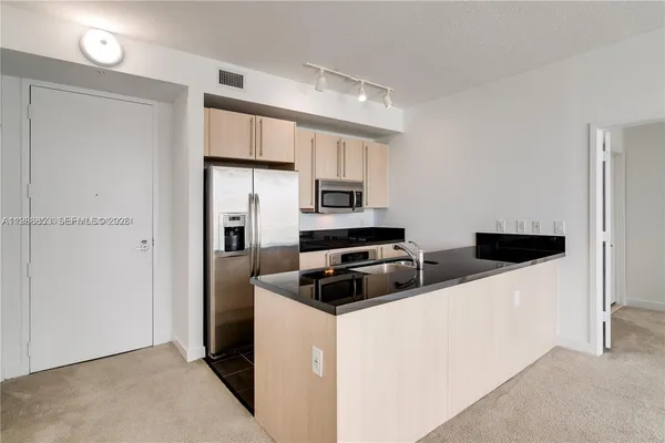 a kitchen with stainless steel appliances a refrigerator stove and microwave