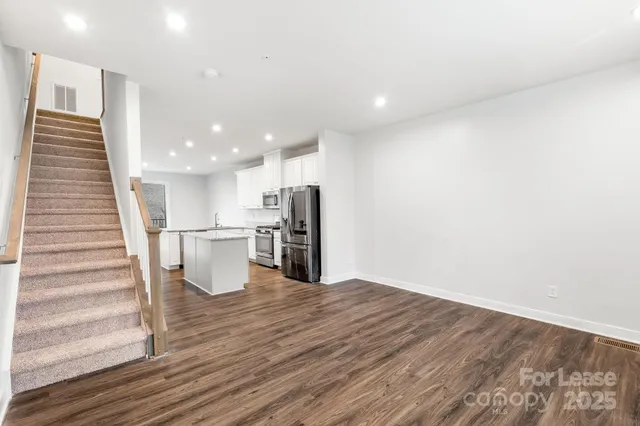 a view of kitchen with wooden floor and electronic appliances