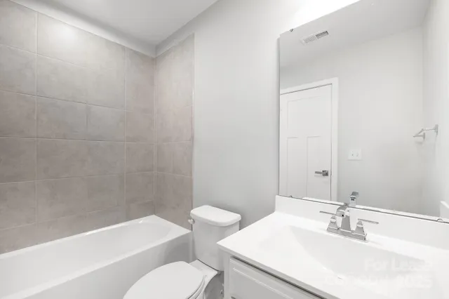 a bathroom with a sink toilet and bathtub