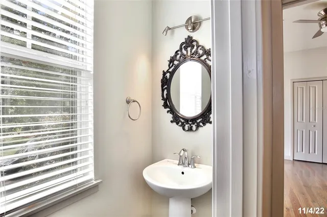 a bathroom with a sink a mirror and a window