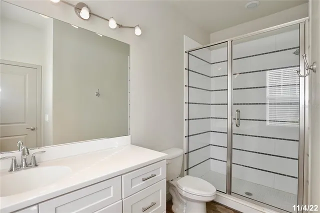 a bathroom with a toilet a sink and a shower