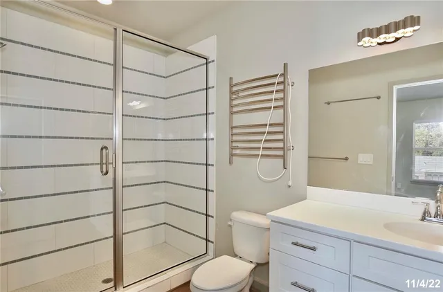 a bathroom with a shower toilet and sink