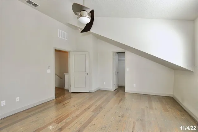 a view of a room with wooden floor and white walls