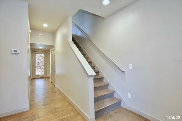 a view of an entryway with wooden floor