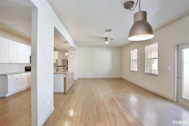 a view of a kitchen and an empty room