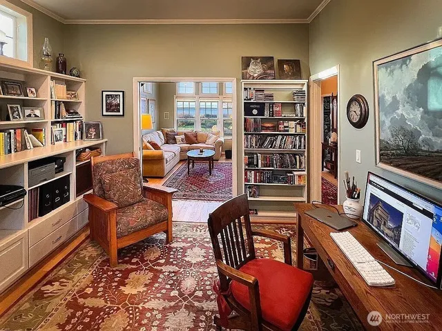 a living room with furniture cabinets and window
