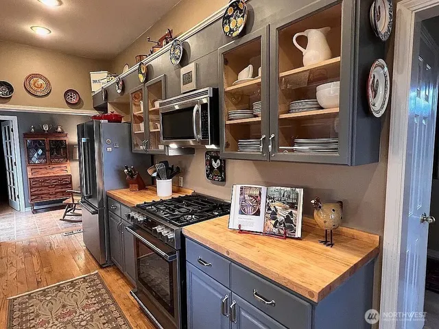 a kitchen with stainless steel appliances granite countertop a stove and a sink