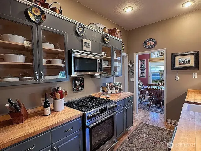 a kitchen with stainless steel appliances granite countertop a stove and a microwave
