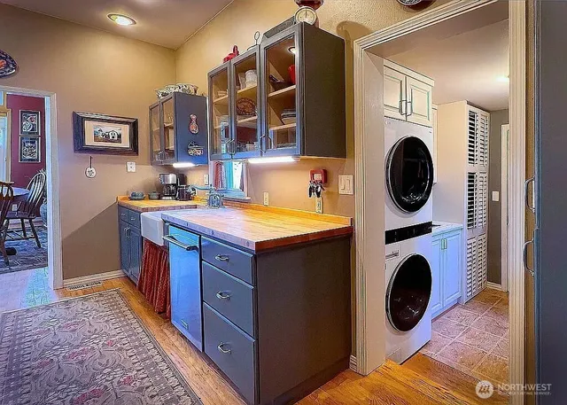 a view of a kitchen with a sink a washer and dryer