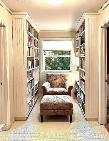 a living room with furniture and a book shelf