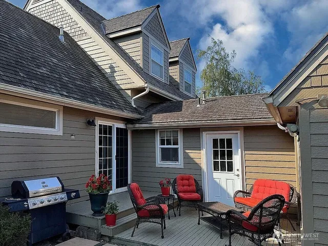 a backyard of a house with fire pit and outdoor seating