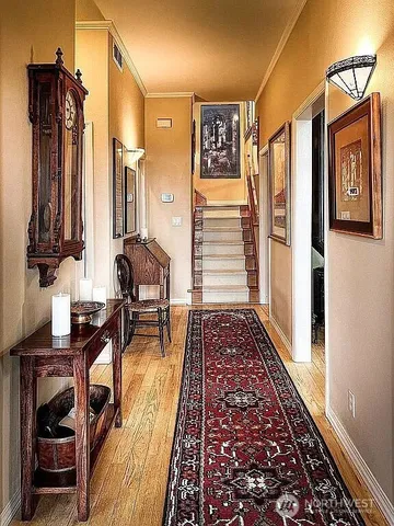 a view of living room with furniture and wooden floor