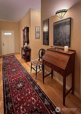 a living room with a rug and a table