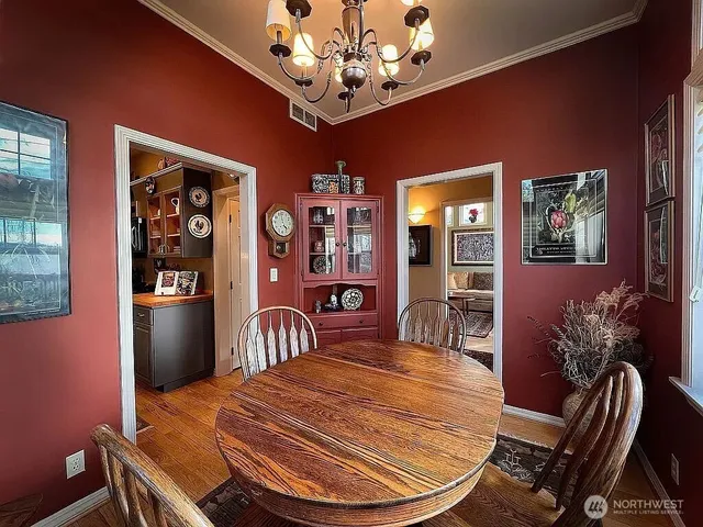 a dining room with furniture and chandelier