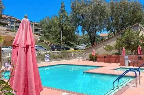 a view of a backyard with swimming pool
